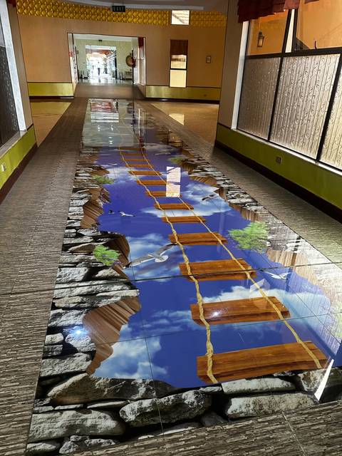 Visual artwork of a 3D bridge illusion.