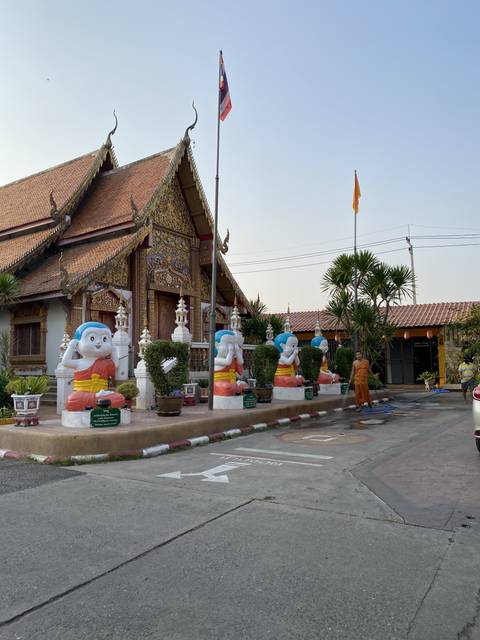       An ornate temple facade with elephant statues.
  