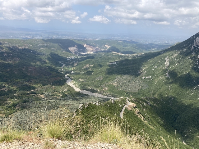 Expansive valley and river with mountains in the background.