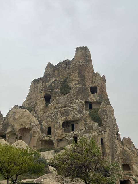       Cave dwellings carved into rocky hills.
  