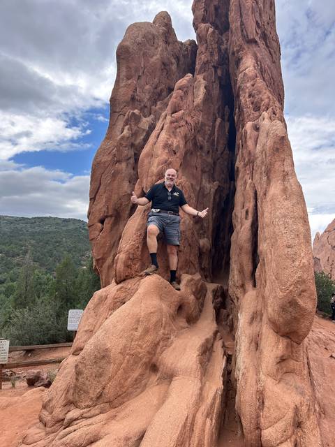 Man climbing rock formations.