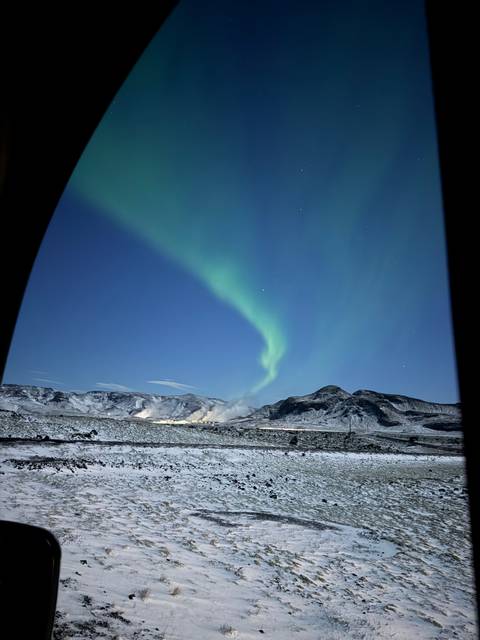Aurora Borealis over a snowy landscape.