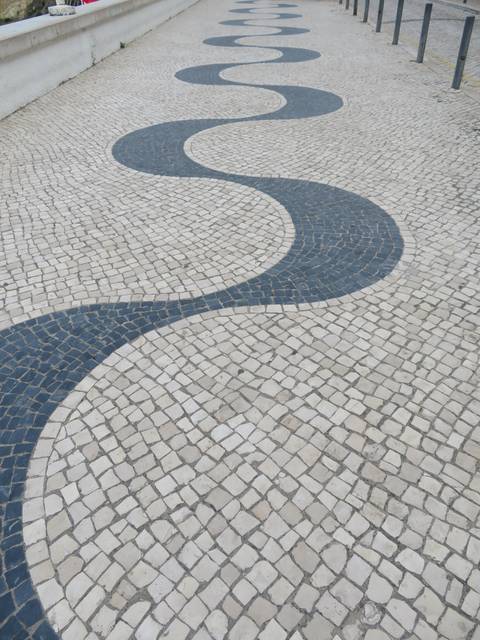       Mosaic tiled pavement with a wave pattern.
  