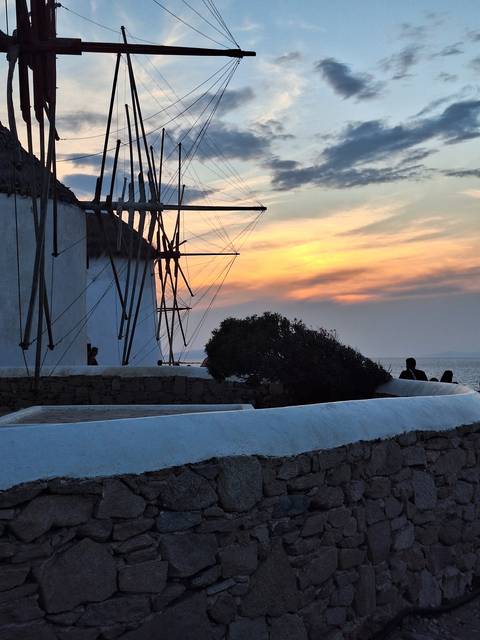 Sailboat masts with a colorful sunset background.