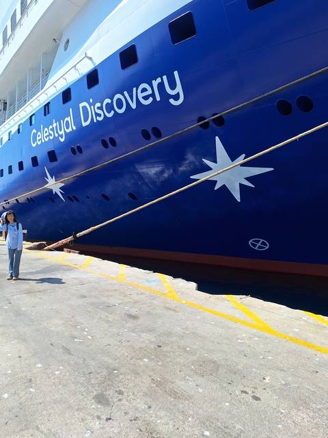 Ship with blue and white color scheme and name 'Celestyal Discovery'.