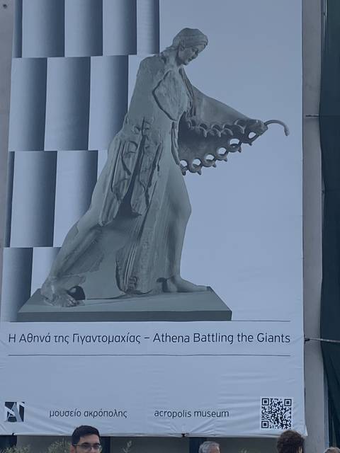       Exhibit of a statue at a museum.
  