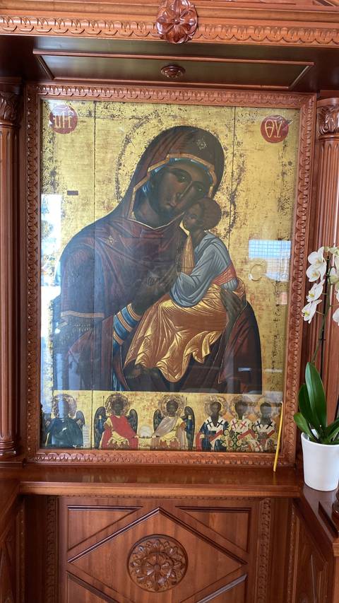       Decorative religious icon in a wooden frame.
  
