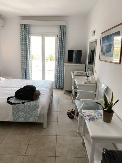       Hotel room interior with a view outside.
  