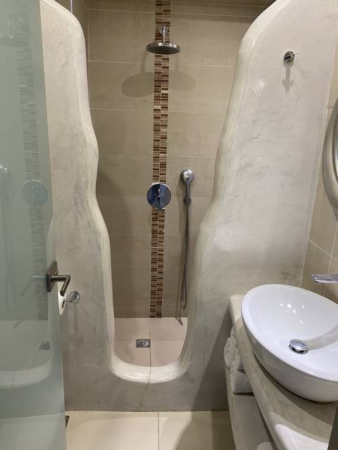       Modern bathroom with a shower and sink.
  