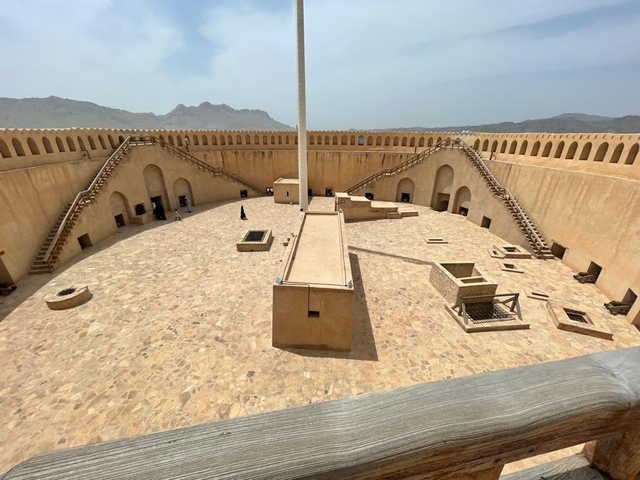       Interior courtyard of a fortress with staircases.
  