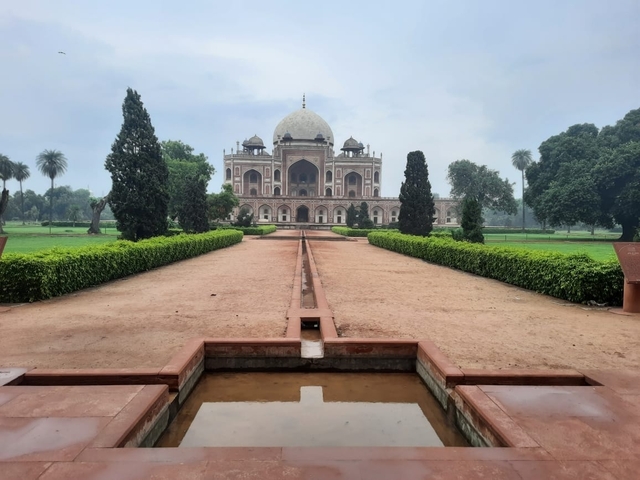       Majestic mausoleum with a well-kept garden path.
  