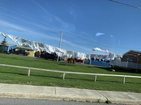 Clothes hanging outside a row of colorful houses.