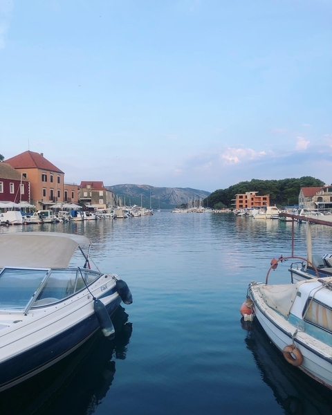 Harbor with boats and surrounded by colorful buildings.