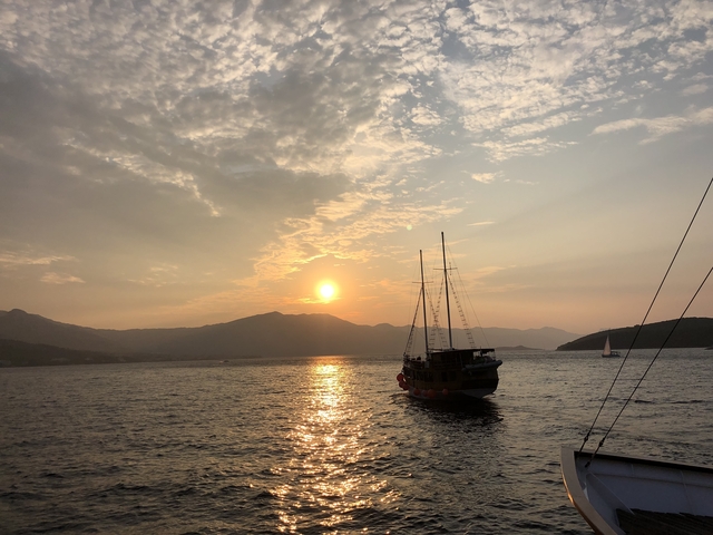 Sailboat on the water during a golden sunset.