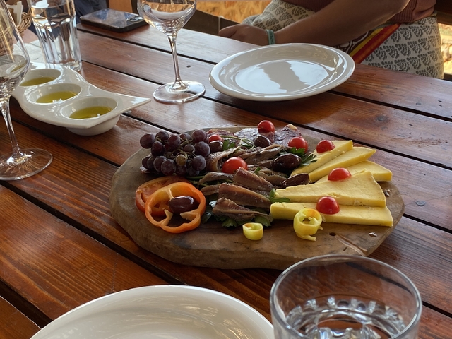 Platter of appetizers on a wooden table ready to serve.