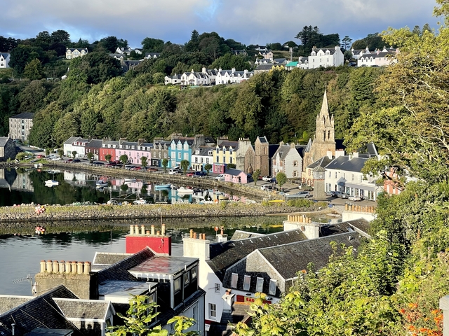 Colorful houses along a waterfront in a scenic town.
