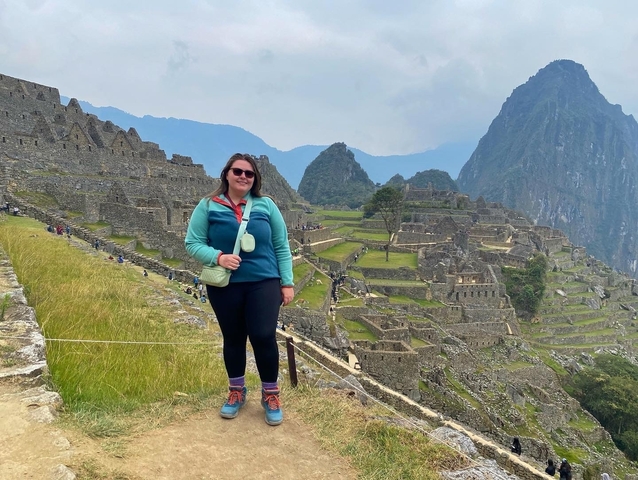 Person posing at the Machu Picchu ruins.