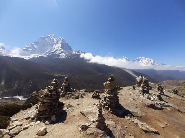       Stony landscape with snowy peaks in the background.
  
