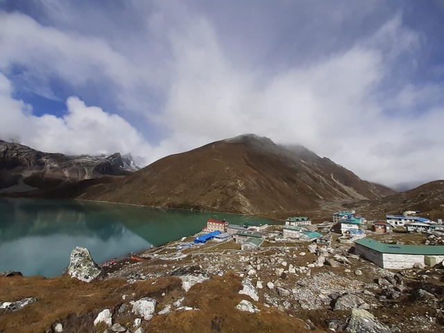       Gokyo village with surrounding mountains and lake.
  