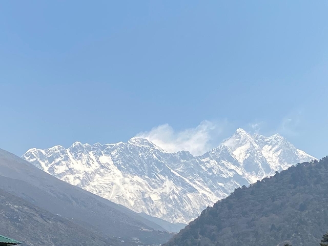       Distant snow-capped peaks under a clear sky.
  