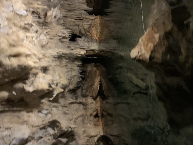       Blurred view inside a cave with stalactites.
  