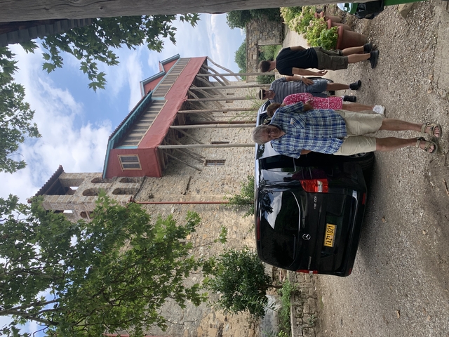       People standing in front of a historic building.
  