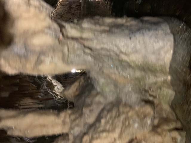       Blurred cave scene with rock formations.
  