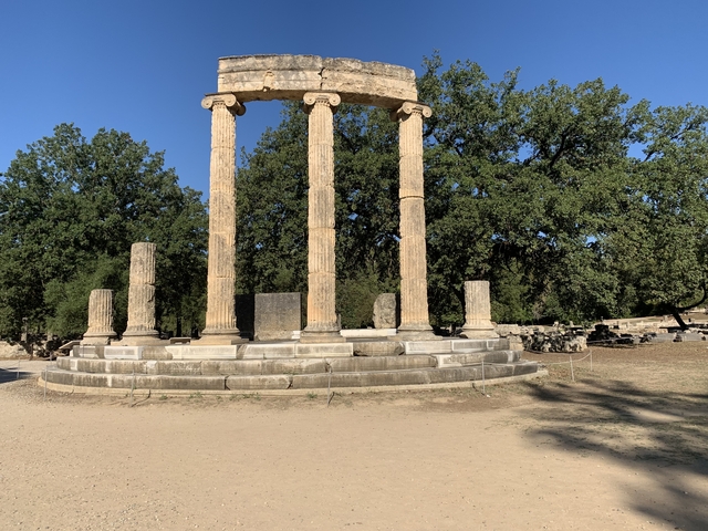       Ruins of ancient Greek columns and structures in an archaeological site.
  