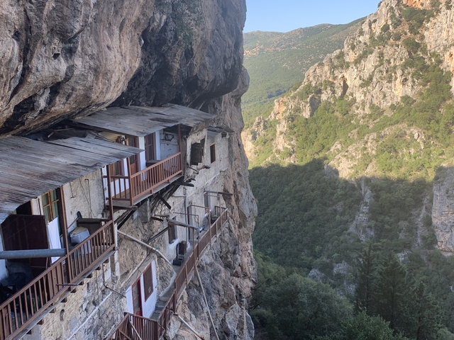       Cliffside dwelling integrated into a rocky mountain face.
  