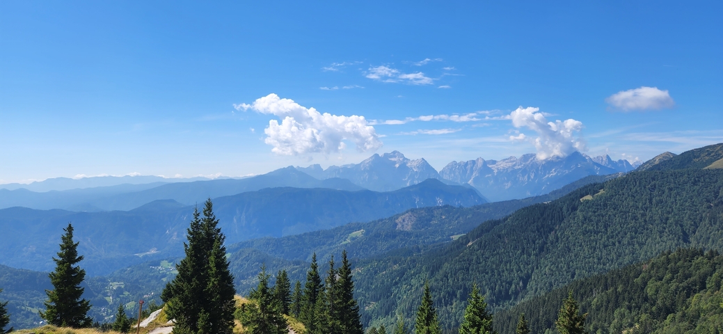       Mountain range with blue sky and clouds.
  