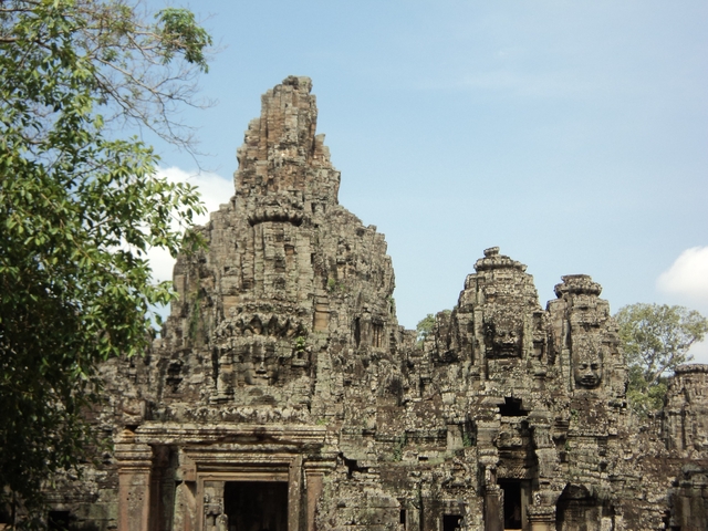 Ancient temple ruins surrounded by trees.