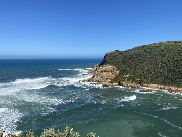 Scenic view of a rocky coastline with waves crashing.