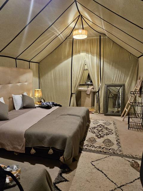 Interior of a luxurious tent with elegant furnishings.