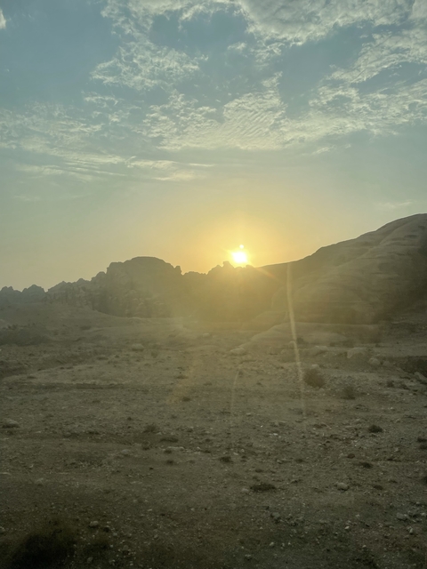       Sunset view over rocky desert landscape.
  