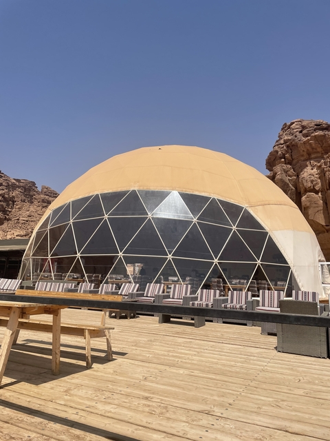       Geodesic dome tent in a desert setting.
  