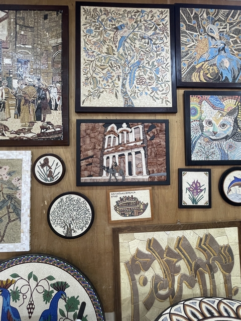       Wall with framed artworks, including a depiction of Petra.
  