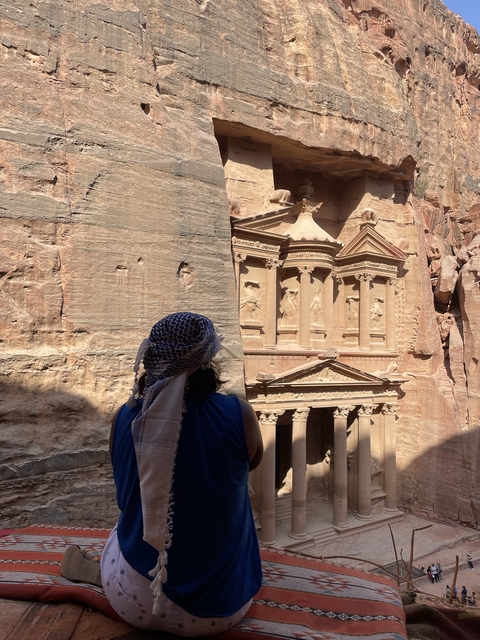 Woman facing the Treasury in Petra.