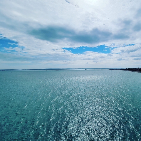 Expansive view of the sea with a blue sky.