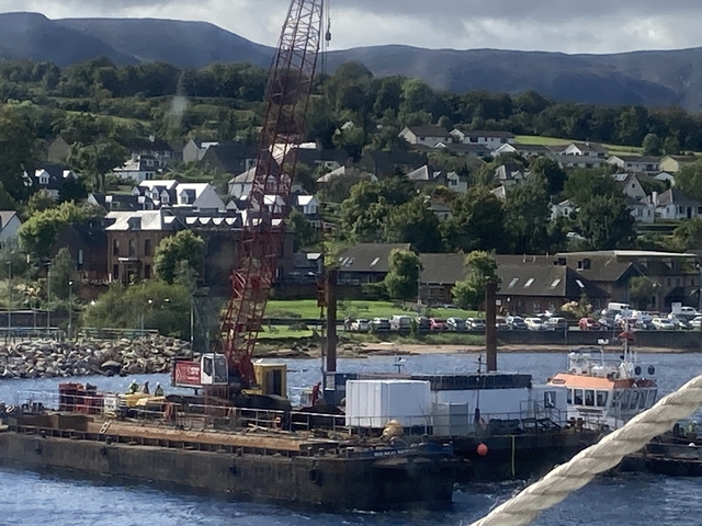       Coastal town with construction site by the water.
  
