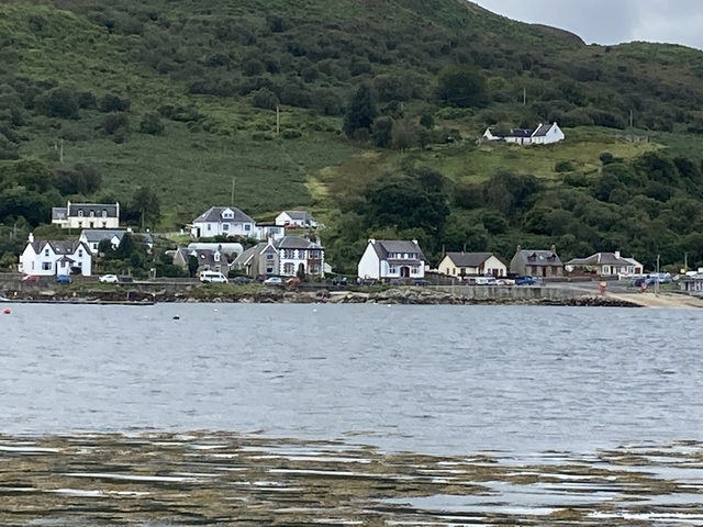 Coastal village with houses across water.