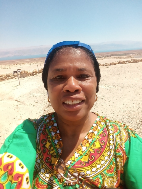 Close-up selfie with desert scenery behind.