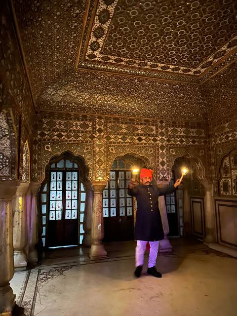 Person in a traditional setting with candles.