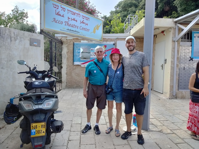 Group of people posing in front of a cultural center.