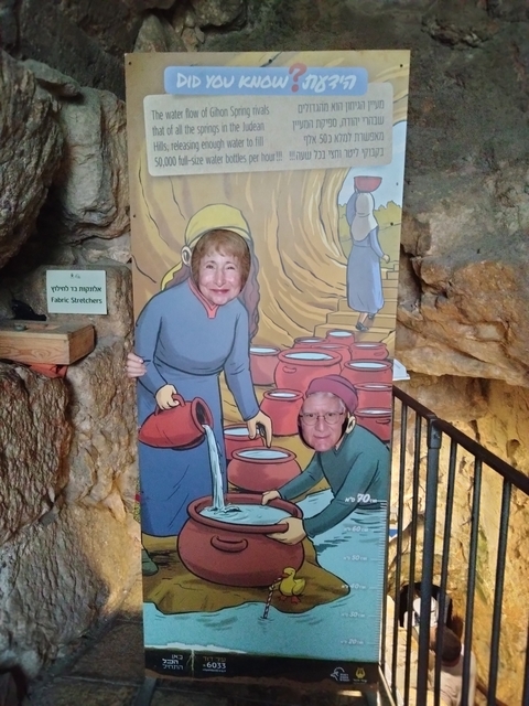       Two people posing with a face-in-hole display.
  