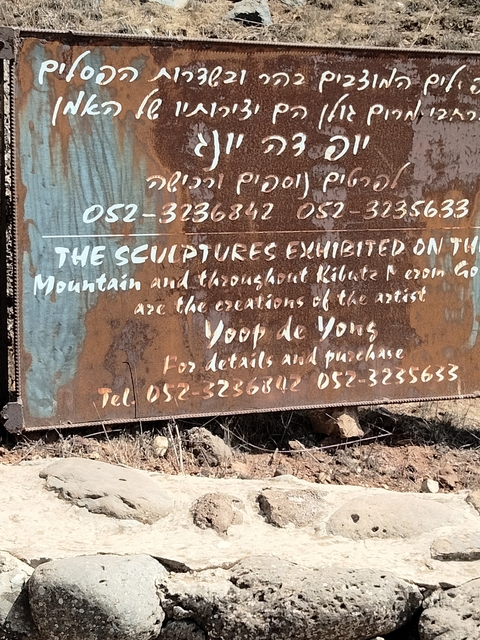       Rusty sign with white text providing information.
  