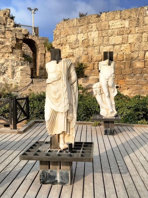 Ancient marble statues displayed outdoors.