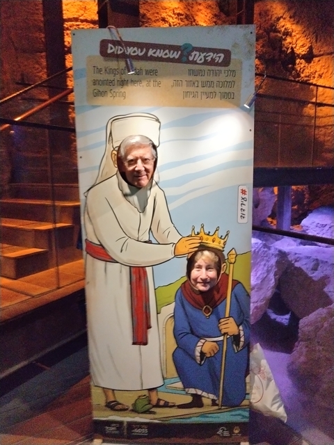 Two people posing with faces inserted in a cardboard cutout.