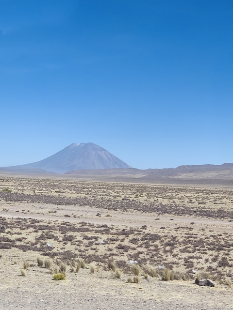 Large solitary volcano in a barren landscape.