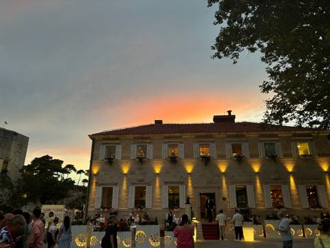 Building facade at sunset with a city landscape.