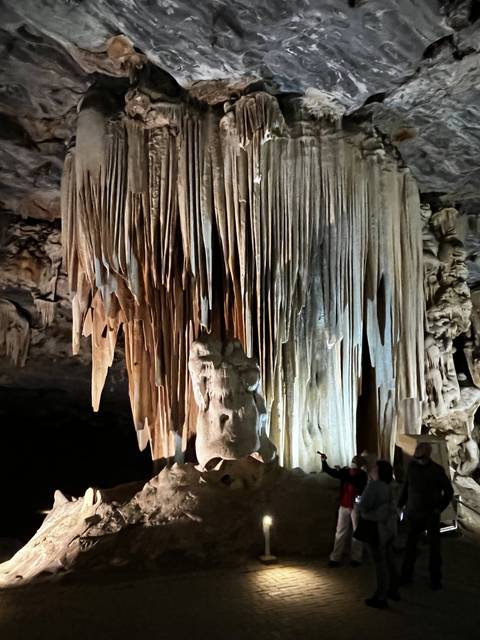 Cave with stalactites and a pathway.